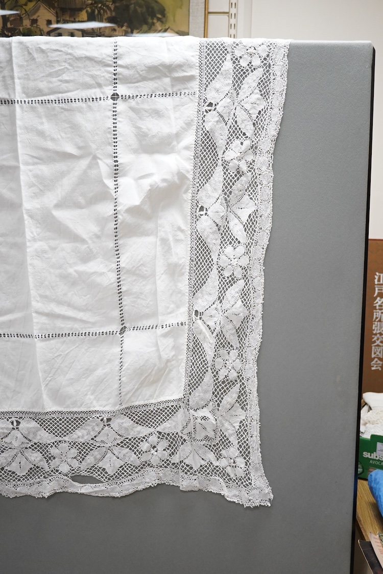 Two boxes of mixed white on white embroidered linen and cotton table cloths etc, some with crochet edging and cut work.